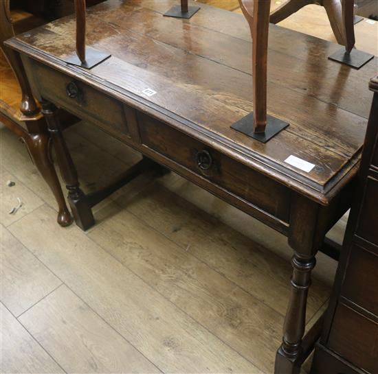 An oak side table with two drawers, W.107cm